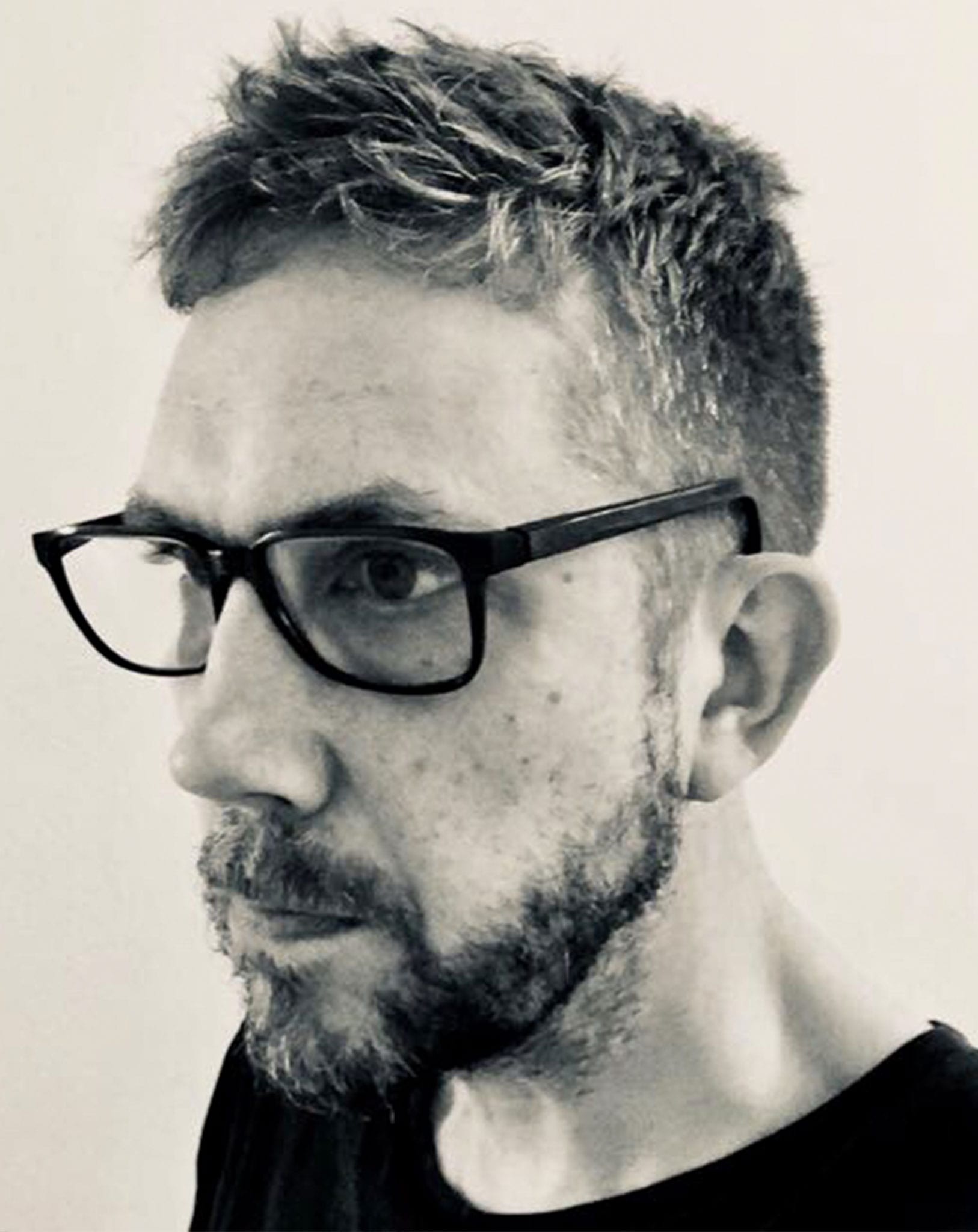 Designer Kurt Stengel, black and white photo of mans face wearing glasses with a beard